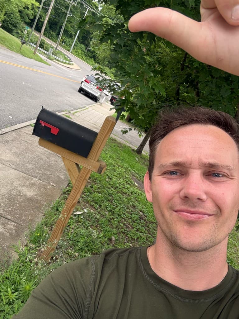 Mailbox Bros team member at a finished black post-mount mailbox install in Nashville